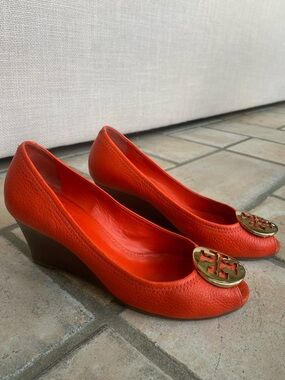 Tory Burch Red/Orange Pebbled Leather Wedge Pumps with Gold Logo Medallion